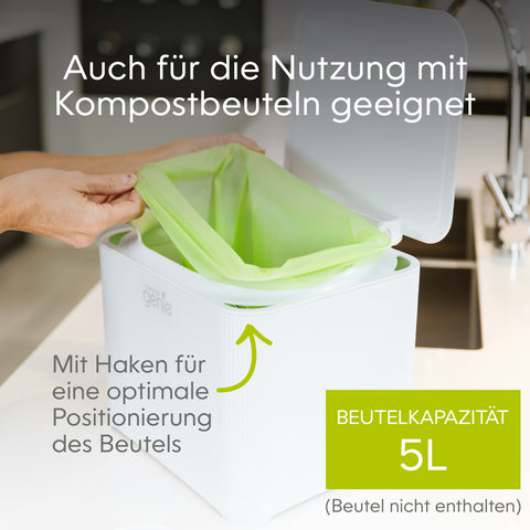 White trash bin with green compostable bag being inserted, kitchen setting_DE-DE