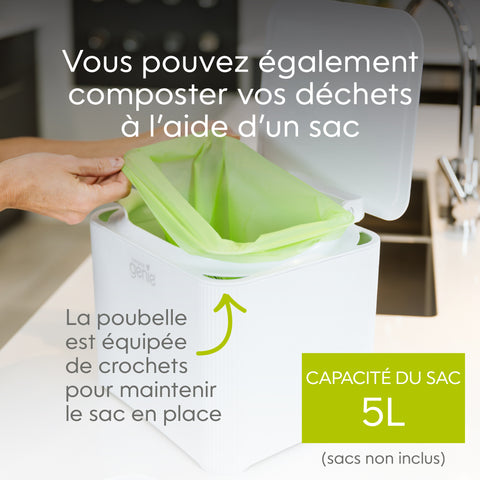 Person using a compostable waste bin with a green bag in a kitchen setting_FR-FR